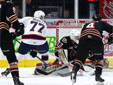 The Regina Pats' Matt Bradley scores a between-the-legs goal Saturday against the Calgary Hitmen.