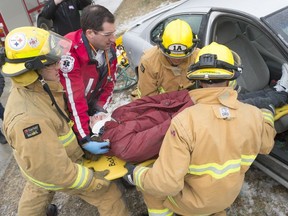 Regina Fire and Protection Services and EMS crews remove Martin Collegiate student Sebastian Eger from a car during a mock accident at Canadian Blood Services.