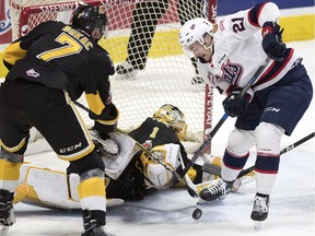 Brandon Wheat Kings goalie Logan Thompson watches as the Regina Pats' Nick Henry tries to got a shot off during WHL action at the Brandt Centre on Wednesday.