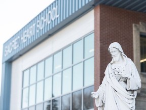 A statue of Jesus Christ is situated in front of Sacred Heart School in Regina. As faith is a focus in Regina Catholic schools, teachers require a clergy reference to be hired.