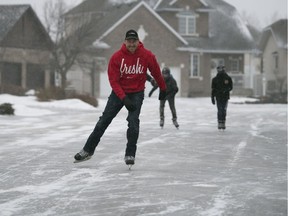 Regan Quayle skates on the street outside his house in Regina.