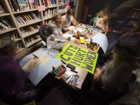 People make signs at the UR Pride Centre to carry in Saturday's Women's March in Regina.