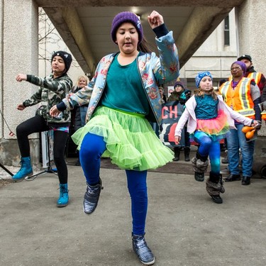 Iris James, front, dances in front of the YWCA with friends as music stirs up a large crowd of particpants preparing to take part in the Women's March Regina on Jan. 20, 2018.