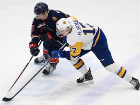 The Saskatoon Blades' Eric Florchuk battles for the puck with Scott Mahovlich of the Regina Pats during WHL action at SaskTel Centre on Feb. 11, 2018.