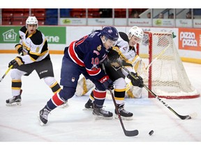 Jonny Hooker of the Brandon Wheat Kings and Austin Pratt of the Regina Pats battle for the puck during WHL action at Westoba Place on Tuesday night.