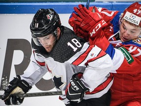 Russia's forward Kirill Kaprizov (R) vies for the puck with Canada's forward Linden Vey during the Channel One Cup of the Euro Hockey Tour ice hockey match between Canada and Russia in Moscow on December 16, 2017.