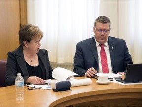 Finance Minister Donna Harpauer and Premier Scott Moe watch the federal budget being announced on TV from the finance minister's office in the Legislative Building in Regina.