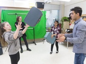 Deaf Crows Collective member Sable, left, Fatima Nafisa, centre right, and Mustafa Alabssi, right, practise juggling suitcases, as artist-in-residence Chrystene Ells, centre left, looks on during a rehearsal for Apple Time.