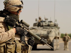 Canadian soldiers with the NATO-led International Security Assistance Force (ISAF) walk during a patrol in Panjwayi district in the west of Kandahar province on March 28, 2008.