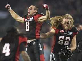 Ottawa Redblacks wide receiver Jake Harty (8) and Redblacks linebacker Tanner Doll (52) celebrate their victory over the Calgary Stampeders during overtime CFL Grey Cup action Sunday, November 27, 2016 in Toronto. The Saskatchewan Roughriders signed Canadian free-agent receiver Harty to a two-year contract Sunday.