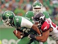 One of the lingering questions surrounding the Saskatchewan Roughriders pertains to whether they can provide better protection for quarterbacks such as Brandon Bridge, who is shown being sacked by the Calgary Stampeders' James Vaughters last season.