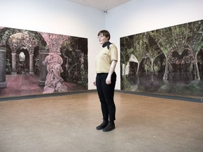 Assistant curator Blair Fornwald stands inside the Dunlop Art Gallery and Grottesque, an exhibition of grotto-inspired paintings by Winnipeg artist Bev Pike.