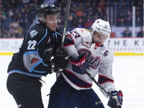 Regina Pats captain Sam Steel battles for the puck with Kootenay Ice forward Brett Davis during WHL action at the Brandt Centre on Friday.