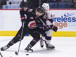 Regina Pats centre Jake Leschyshyn battles to take the puck away from Moose Jaw Warriors forward Tristin Langan during WHL action at the Brandt Centre on Feb . 14.
