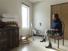 Gwyn Tremblay, executive director of SOFIA House, sits in the bedroom of one of the organization's apartments.