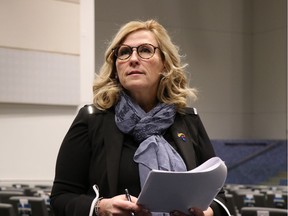 Armed with budget documents, Ward 4 Coun. Lori Bresciani fields questions from residents at a Regina City Council town hall meeting at Living Hope Alliance Church on Tuesday.