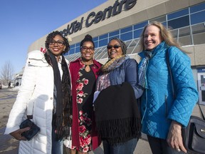 Kay Doxilly, left to right, Winifred George, Rahab Bwanka, and Cerise Zaren stand for a photograph before entering SaskTel Centre to see Michelle Obama speak in Saskatoon, SK on Thursday, March 22, 2017.