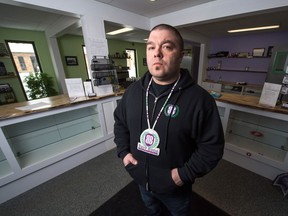 Pat Warnecke, the owner of Best Buds Society in the Warehouse District in Regina, poses for a portrait in his shop after it was raided by police.