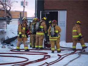 Firefighters deal with an incident at Indiglow Signs & Graphics on the 100 block of Fourth Avenue East Wednesday