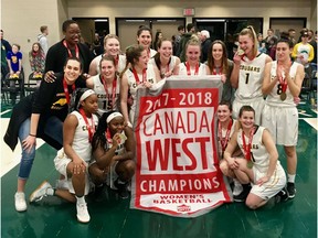 The University of Regina Cougars celebrate after winning the Canada West women's basketball championship on Friday.