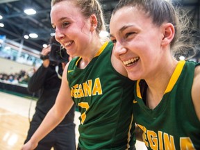 The University of Regina Avery Pearce, right, and Sara Hubenig react after the end of the bronze medal game game against McGill University in Regina.