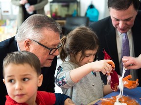 Federal MP Ralph Goodale (left) and provincial Education Minister Gord Wyant (right) crafted with Severn Kramer-Cadenne (left) and Bridget McMurray as part of their announcement of early years education funding on March 16 in Regina.