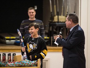 Mathew Bird wins a miniature hockey stick at a school assembly at Glen Elm School in Regina.