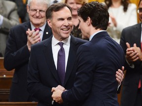 Finance Minister Bill Morneau is congratulated by Prime Minister Justin Trudeau after delivering the federal budget in the House of Commons in Ottawa on Tuesday, Feb. 27, 2018.