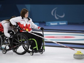 Marie Wright, right, of Canada throws a stone during the Wheelchair Curling Bronze Medal Game between South Korea and Canada at the Gangneung Curling Centre in Gangneung, South Korea at the 2018 Winter Paralympics Saturday, March 17, 2018. (Joel Marklund/OIS/IOC via AP) ORG XMIT: OLYMY826