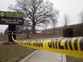 Crime scene tape is used around Great Mills High School, the scene of a shooting, Tuesday, March 20, 2018, in Great Mills. A student with a handgun shot two classmates inside the school before he was fatally wounded during a confrontation with a school resource officer, a sheriff said.