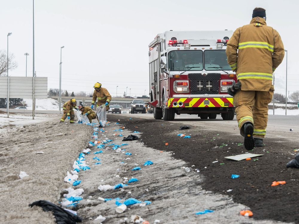Regina firefighters picking up discarded medical supplies on Ring Road