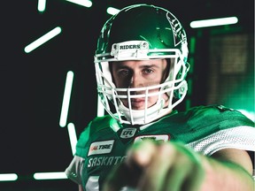 Riders quarterbac Zach Collaros shows off his new jersey while meeting with the Regina media on Jan. 9.