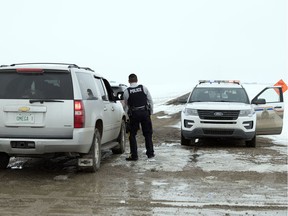 An RCMP cruiser sits at the corner of Range Road 2195 and Township Road 184 just north of Regina on March 19, 2018.