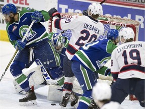 Emil Oksanen of the Regina Pats crashes the net on Monday while Swift Current Broncos goalie Stuart Skinner tries to locate the puck through a crowd.