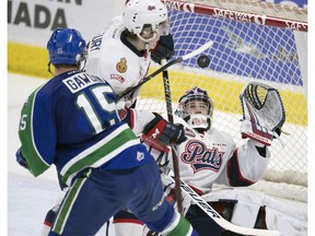 Regina Pats goalie Ryan Kubic reaches up from his backside to make a glove save in Game 3 of a first-round WHL playoff series against the Swift Current Broncos.