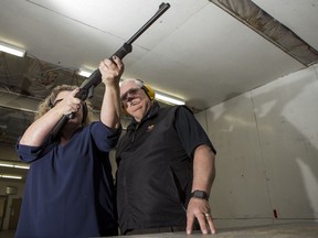 Saskatoon Wildlife Federation president Robert Freberg, right, and Deb Keller demonstrate firearms safety at the SWF's indoor range in January 2017.