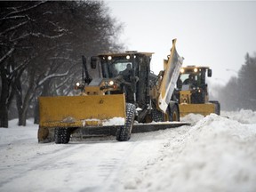 Snow plows took to Regina's streets to move the mountains of snowfall that began falling Saturday.