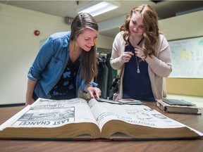 Leader-Post reporter Ashley Martin, left, and another Ashley Martin, right, look at a copy of the Leader-Post from Oct. 17, 1994, as well as a childhood photo album.