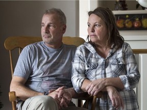 Peter Morris, left, and Jayne Morris are pictured in their Saskatoon home on Dec. 15, 2017. Their 14-year-old daughter Mary-Jayne Morris (not pictured) is hard of hearing and could eventually need a cochlear implant surgery.