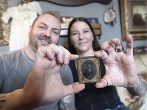 Rob and Karen Baron hold a tintype photo of who they believe could be outlaw Jesse James.