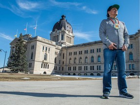 Rod Belanger, a Sixties Scoop survivor and board member of the Sixties Scoop Indigenous Society of Saskatchewan, stands in front of the Saskatchewan Legislative Building in Regina.