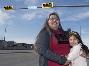 Joely BigEagle-Kequahtooway and her 7-year-old daughter WiYana stand at the corner of Big Bear Boulevard and Pasqua Street in Regina. She fears targets aiming at more Indigenous-themed street names could be "lip service."