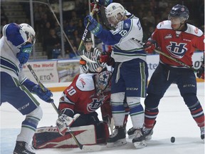 The Swift Current Broncos and Lethbridge Hurricanes battle for a puck in front of goalie Logan Flodell during Game 2 of the Eastern Conference final in Swift Current on Saturday. Photo courtesy Steven Mah/Southwest Booster.