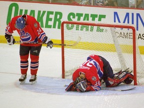 Paul Elliott, left, and Chad Davidson of the Regina Pats are shown in the immediate aftermath of an overtime loss to the visiting Val d'Or Foreurs in the 2001 Memorial Cup semi-final.