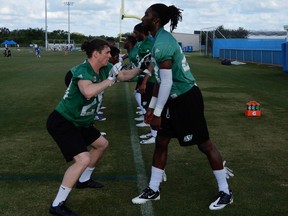 Adam Laurensse, left, works on defensive hand drills with William Johnson Jr. during the Saskatchewan Roughriders' mini-camp Wednesday in Bradenton, Fla.