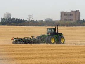 Farmer works his field near Regina.