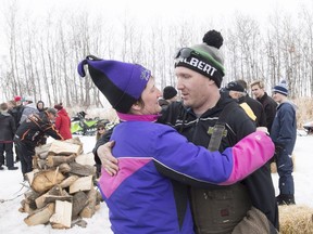 Humboldt Broncos assistant coach Chris Beaudry, right, hugs Adam Herold's mother Raelene as family and friends celebrate what would have been Adam's 17th birthday in Montmartre, Sask. on Thursday, April 12, 2018.