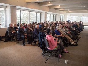 A crowd listens to Aaron A. Fox, a partner at McDougall Gauley LLP, as he speaks at the MacKenzie Art Gallery on "The challenge of justice in Saskatchewan" during a Law Day Lecture.