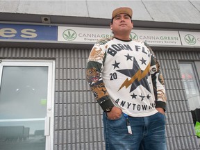 Sarain Stoney, a customer who purchased marijuana at Cannagreen marijuana dispensary on Park Street in Regina, poses for a portrait in front of the store.