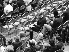 University of Marshall assistant football coach Red Dawson, centre, sits alone during a memorial service in Huntington, W.Va., honouring the 75 people killed in a plane crash the previous day (Oct. 14, 1970).